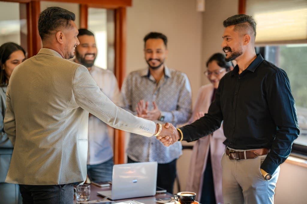Singh Foundation founders shaking hands at a business meeting