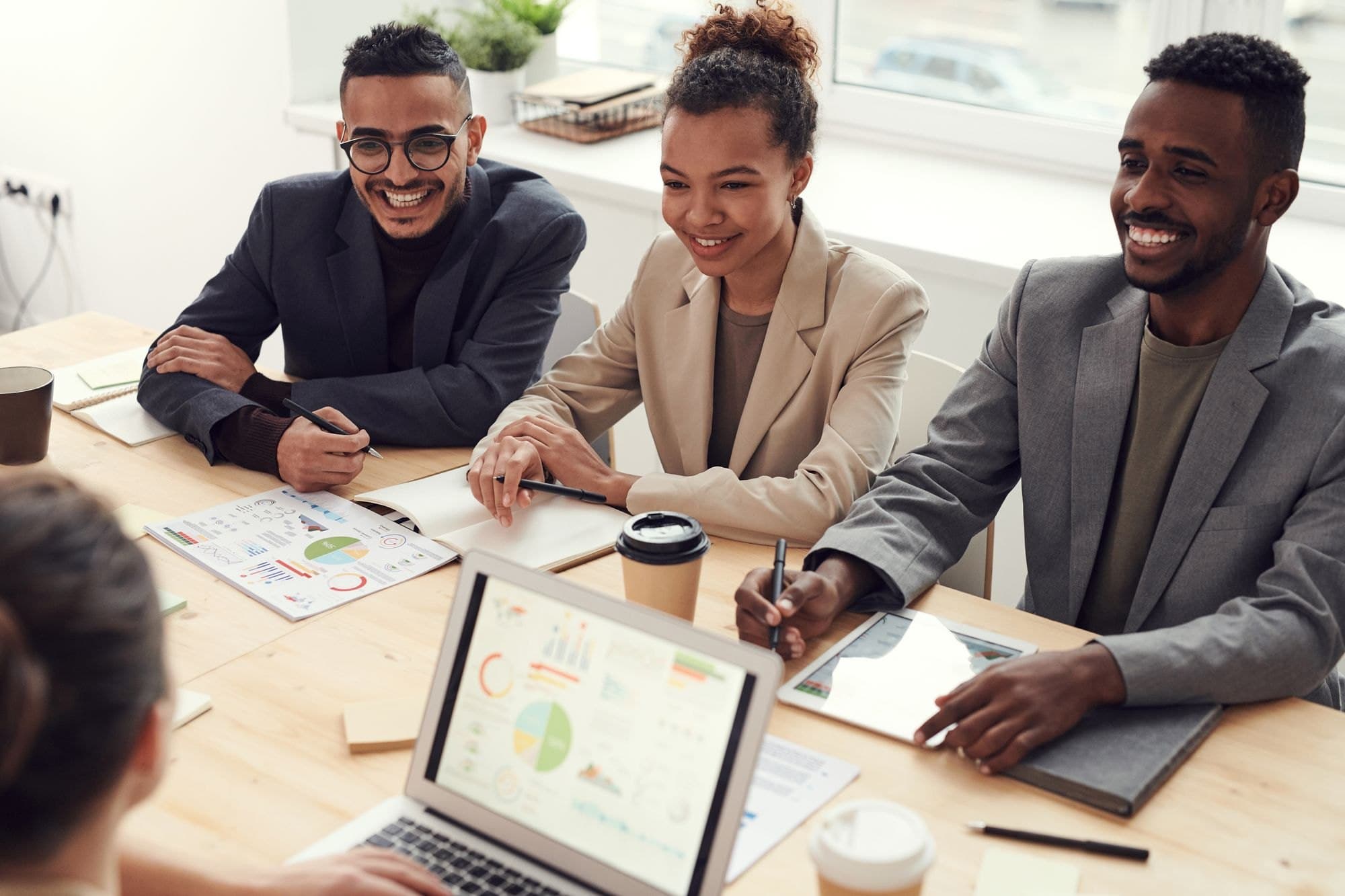 Professionals in conversation at a meeting table